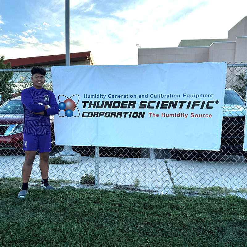 Christian standing next to Thunder's banner.